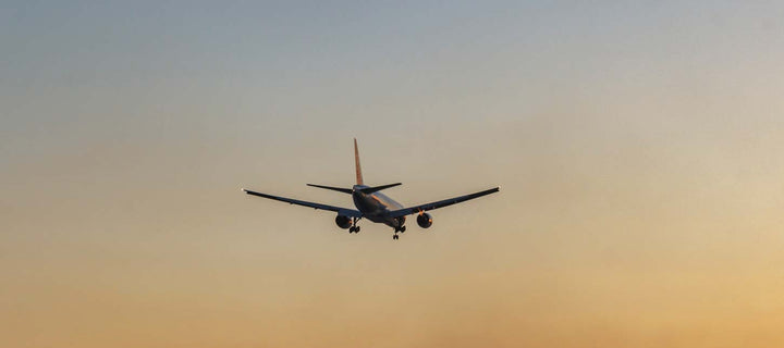 airplane landing in a sunset